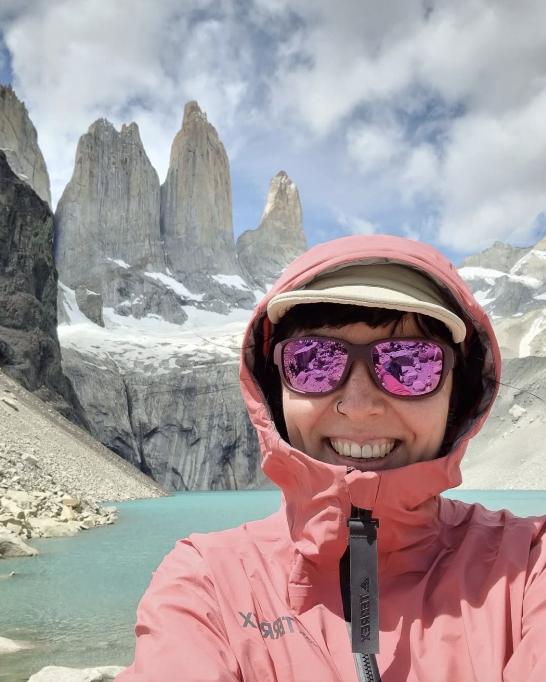 Lara in Patagonia beside a mountain lake